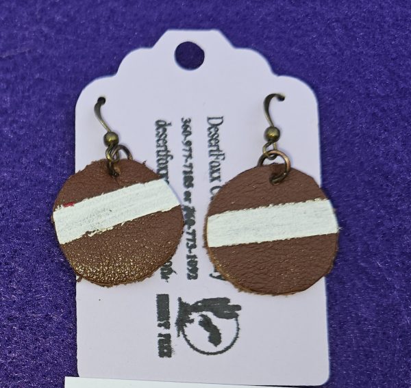 Approximately 1 3/8 inch hand painted round leather earrings with brown and white.