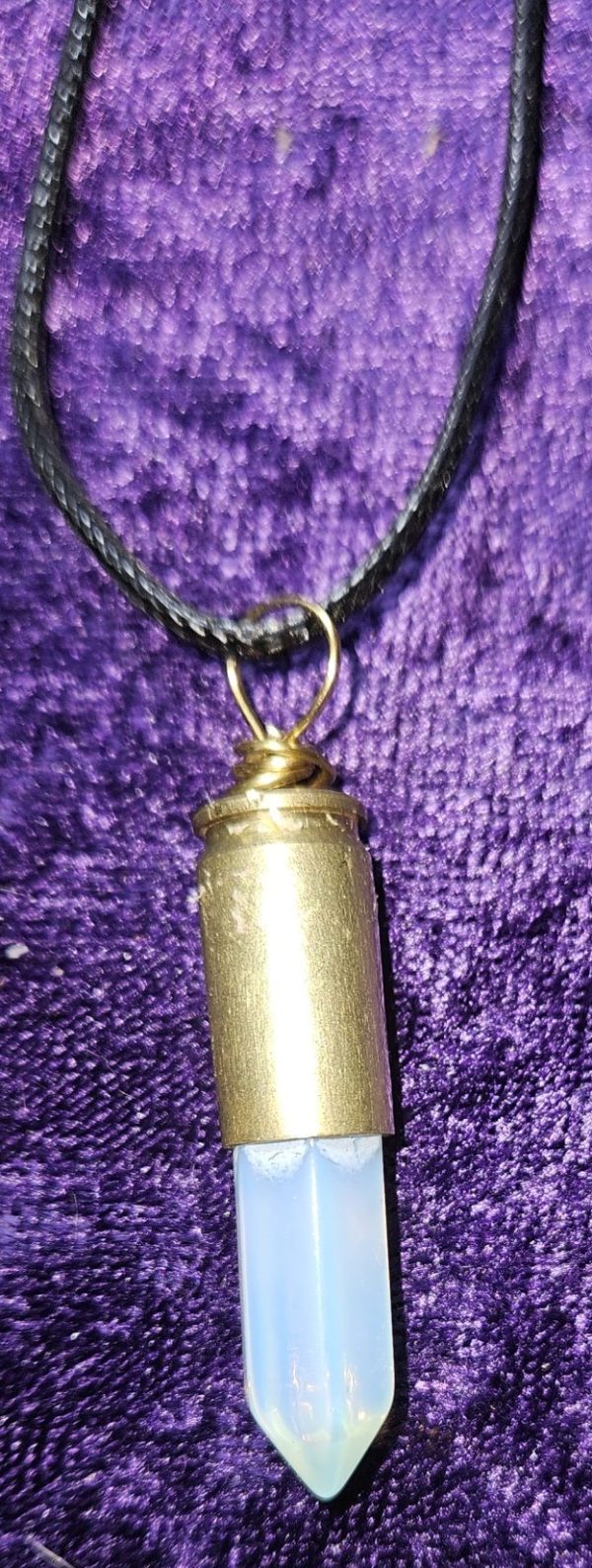 A 22-guage bullet casing with crystal and vinyl cording.