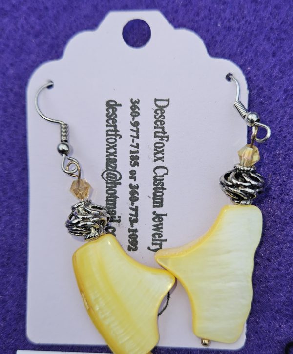 Approximately 1½ inch plastic yellow beads with silver findings stainless steel wires and yellow crystals.