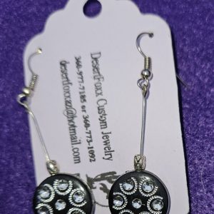 Approximately 2⅛ inches black round disk with silver design finished with four silver findings.