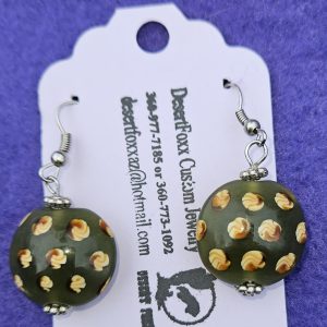 Approximately 1½ inch round beads Green in color with yellow designs and stainless steel ear wires with silver findings.