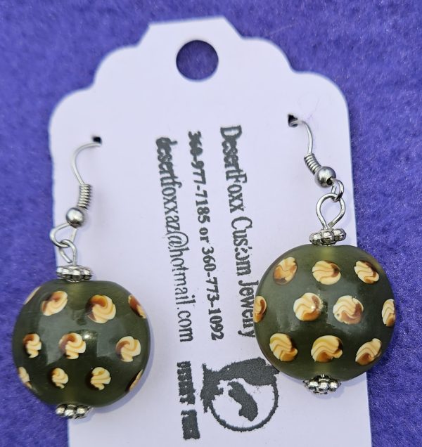 Approximately 1½ inch round beads Green in color with yellow designs and stainless steel ear wires with silver findings.