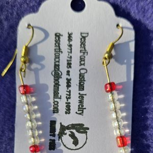 Approximately 2 ¼ inch clear and red beads and gold ear wires.