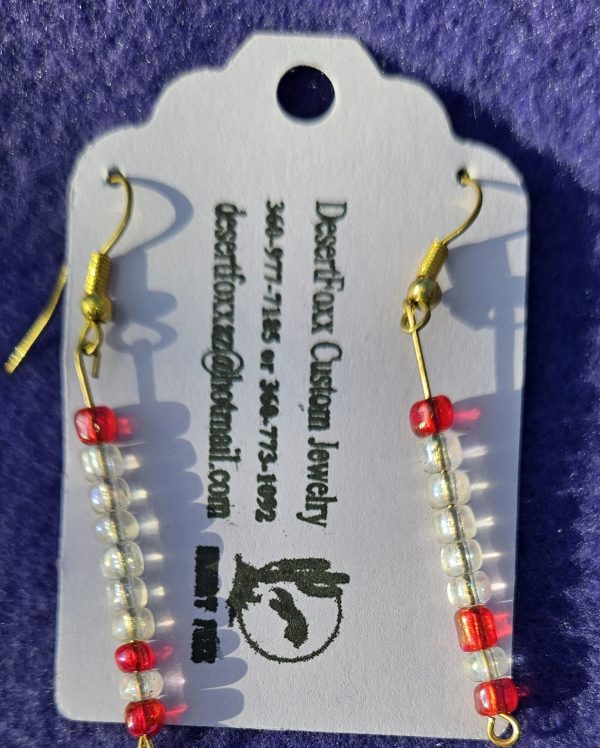 Approximately 2 ¼ inch clear and red beads and gold ear wires.