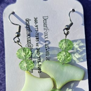 One inch wide plastic findings with 2 inches long green crystals and stainless steel ear wires.