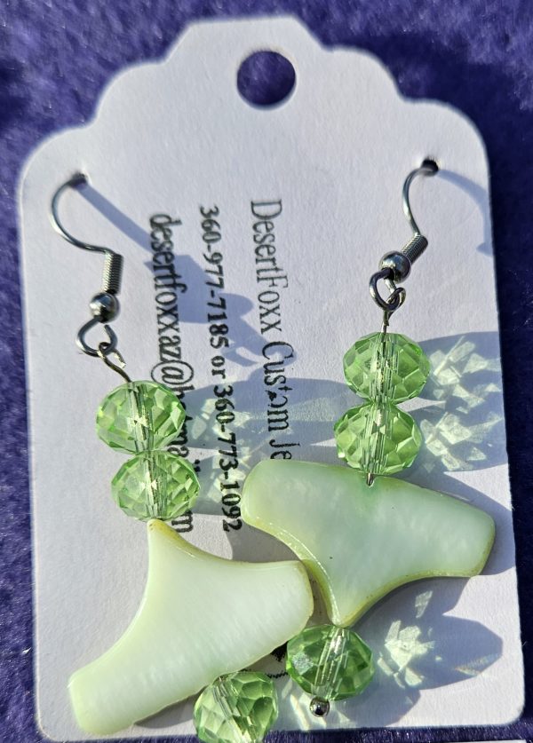 One inch wide plastic findings with 2 inches long green crystals and stainless steel ear wires.