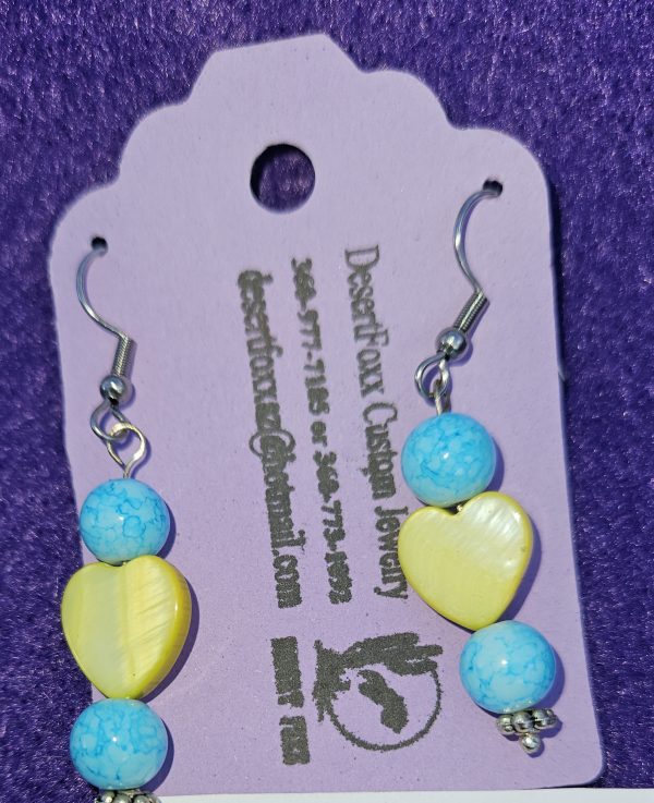 Approximately 2 inches yellow heart beads with two round beads turquoise in color with silver finish findings and stainless steel ear wires.