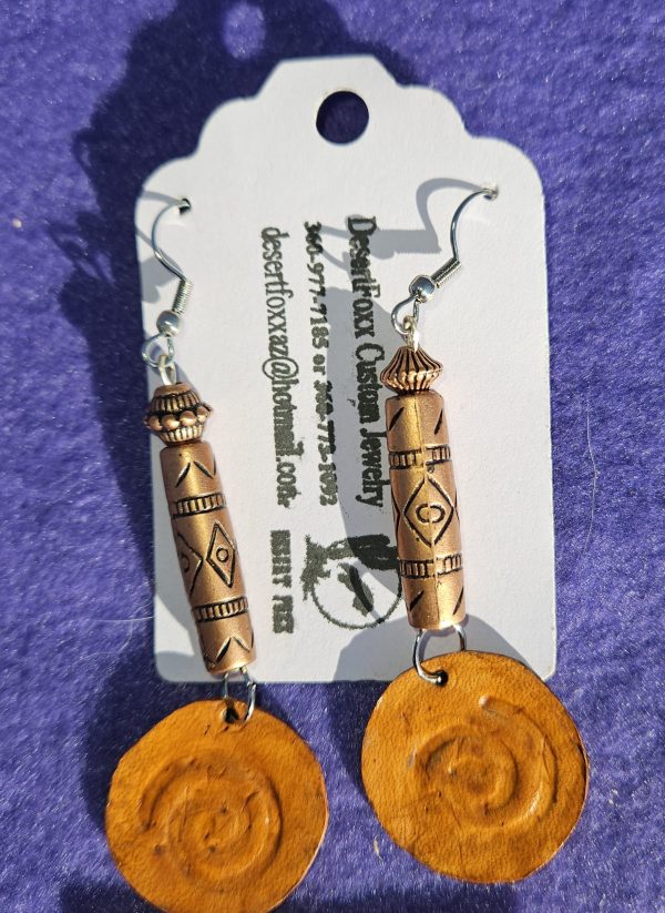 Approximately 3 inches copper colored long beads with black designs and copper be finished with leather Circle disk.