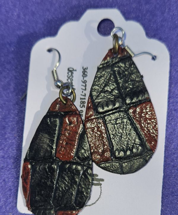 Approximately 2 inches teardrop leather with red hand painted design.