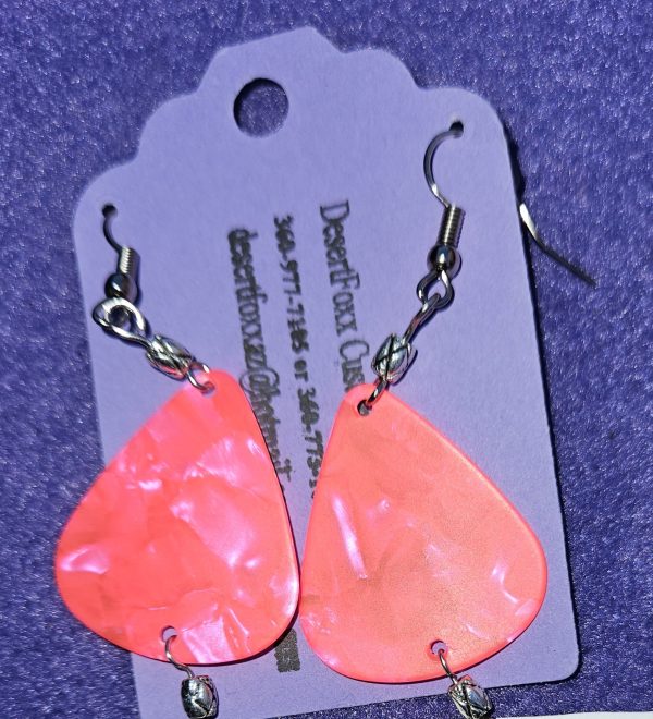 Approximately 2 inches Fluorescent pink guitar pick earrings with silver findings and ear wires.