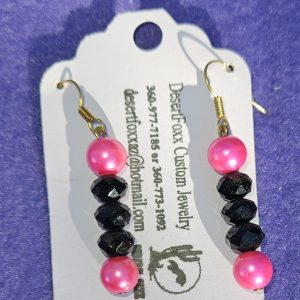 Approximately 1 5/8 inch long. Pink simulated pearls with black crystals.