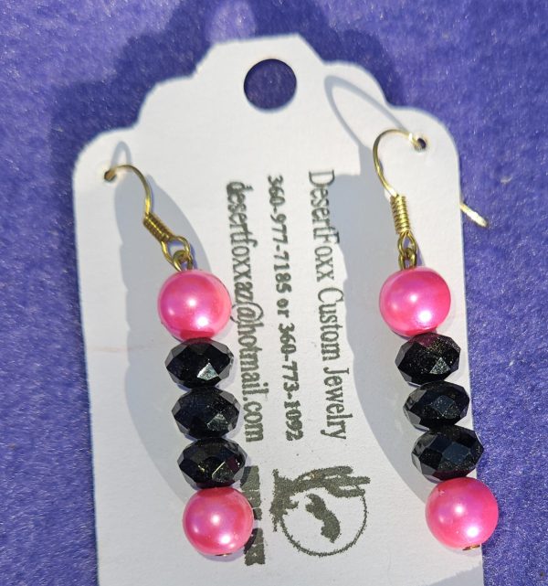 Approximately 1 5/8 inch long. Pink simulated pearls with black crystals.