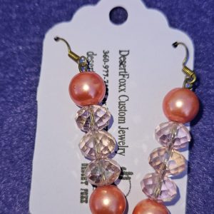 Approximately 2 inches long. Salmon pink simulated pearls with pink pink crystals