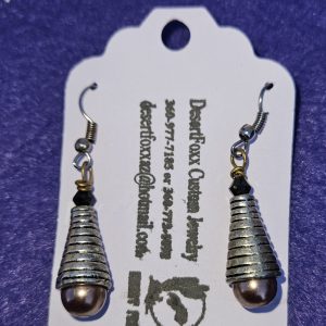 Approximately 1 5/8 inch long. Silver cones with brownish pearlized bottoms and black crystals.