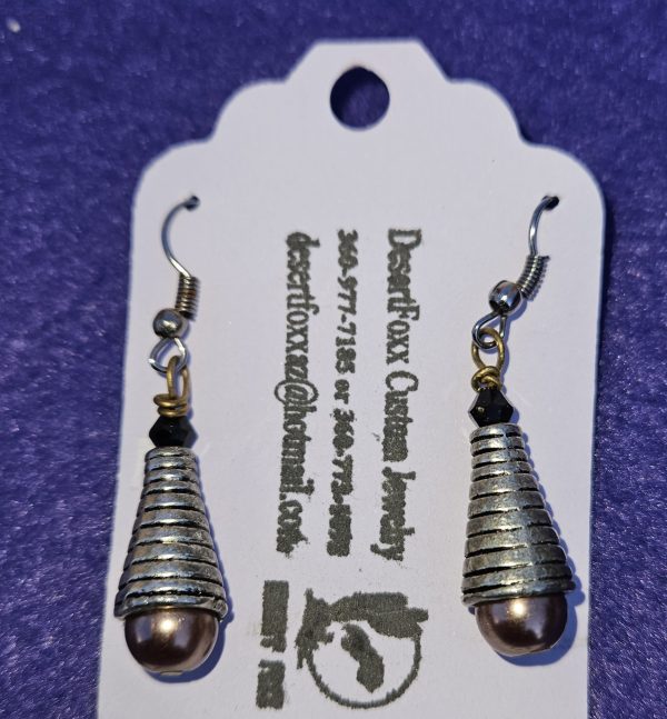 Approximately 1 5/8 inch long. Silver cones with brownish pearlized bottoms and black crystals.