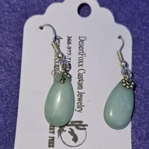 Approximately 1 1/2 inch long. Translucent green teardrop bead with silver colored findings.