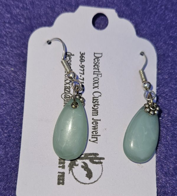 Approximately 1 1/2 inch long. Translucent green teardrop bead with silver colored findings.