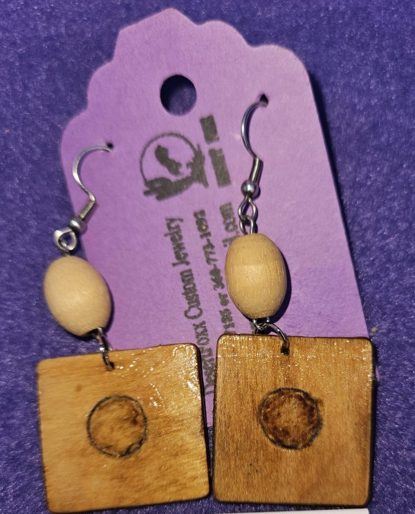 Approximately 2 1/2 inches long. Wooden squares with wood burned designs and wooden beads.