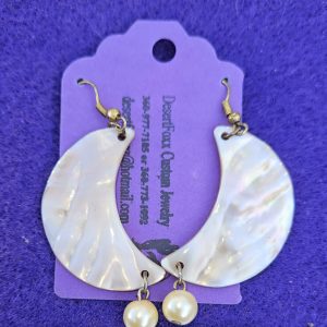 Approximately 2 1/2 inches long. Cream colored half moon shells with simulated pearls.