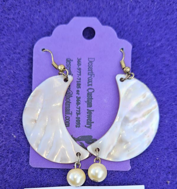 Approximately 2 1/2 inches long. Cream colored half moon shells with simulated pearls.