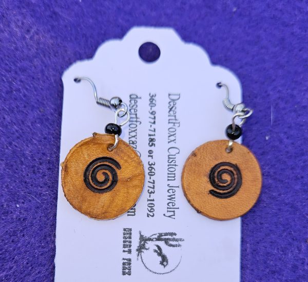 Approximately 1 1/2 inch long. Branded leather disks with black bead and stainless steel wires.