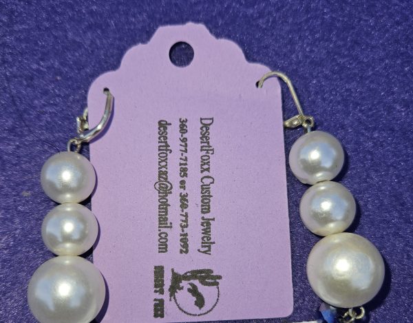 Approximately 2 3/8 inches long. Large simulated pearls, purple beads, and stainless ear wires.