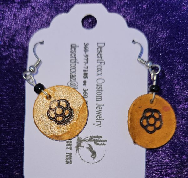 Approximately 1 5/8 inch long. Branded leather disk with black beads.