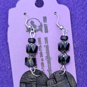 Approximately 2 1/2 inches long. Black beads with silver topped designs, crystal beads, and died / texture with stainless ear wires.