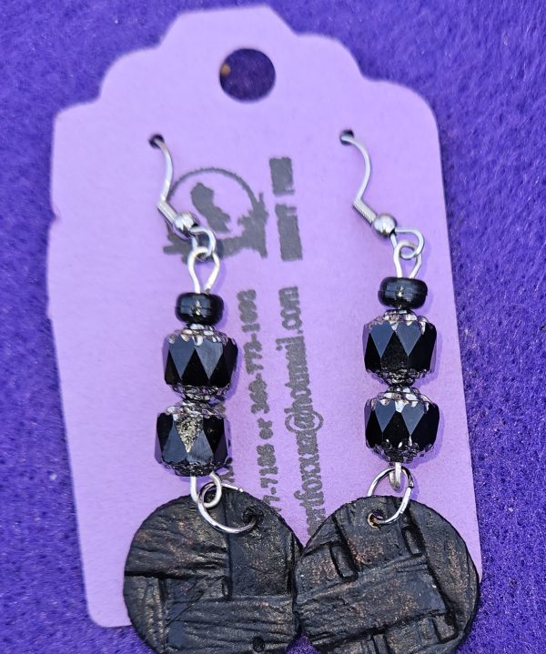 Approximately 2 1/2 inches long. Black beads with silver topped designs, crystal beads, and died / texture with stainless ear wires.