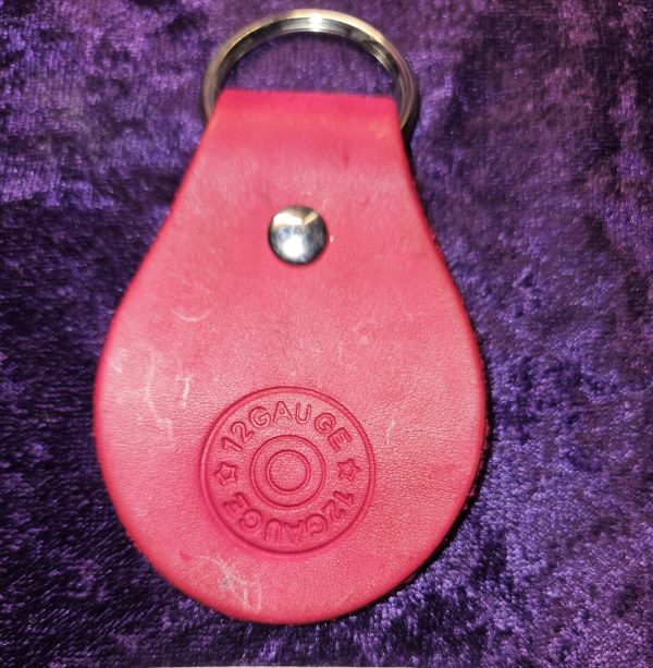 Leather dyed red with shot gun stamp approximately 3 inches long by 2 inches wide.