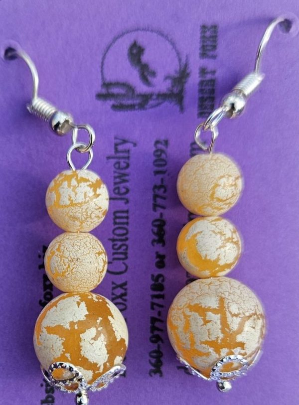Approx 1 5/8 inches, Carmel colored beads with Off-white crackle paint with Silver findings and Silver ear wires.
