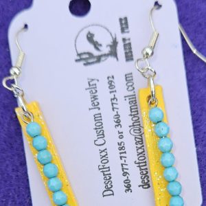 Approx. 2 ⅜ inches, Hand painted wooden Tag dropped earrings with Turquoise colored beads and mod podge sealed.