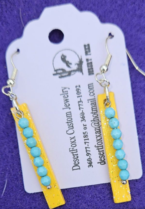 Approx. 2 ⅜ inches, Hand painted wooden Tag dropped earrings with Turquoise colored beads and mod podge sealed.