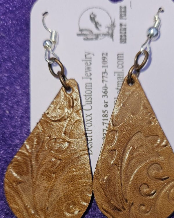 Approx. 2 ¼ inches, Brown tooled Leather tear drop earrings with gold colored ear wires. $21.99