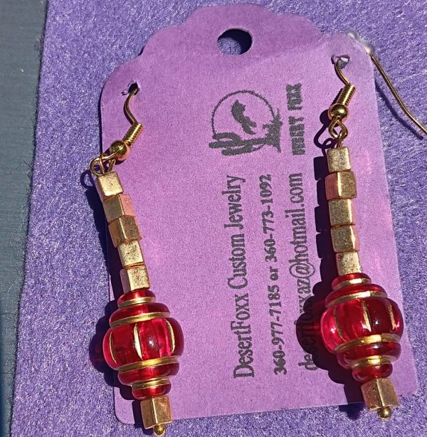 Approx. 2 1/8 inchs Clear red beads with Gold Trim.