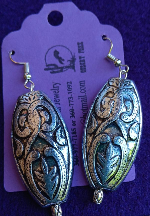 Approx. 2 1/8 inches Silver Egg shaped with silver and black brocaid with silver findings.