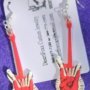 Approx. 2 5/8 inches, Plastic guitar with white base with red and black design with silver ear wires. 21.99
