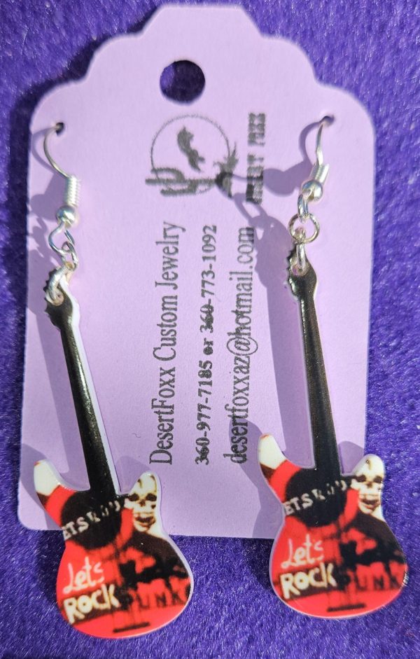 Approx. 2 5/8 inches, Plastic guitar with red, black, and white design with silver ear wires. 21.99