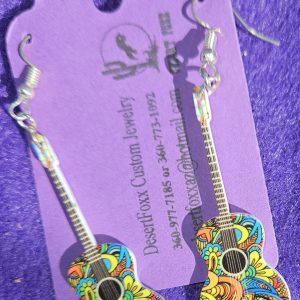 Approx 2 5/8 inches, Plastic guitar with multi colored design with silver ear wires. 21.99