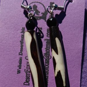 Approx. 2 1/4 inches, Long bead with cream and brown stripes and black beads with silver ear wires. 22.00