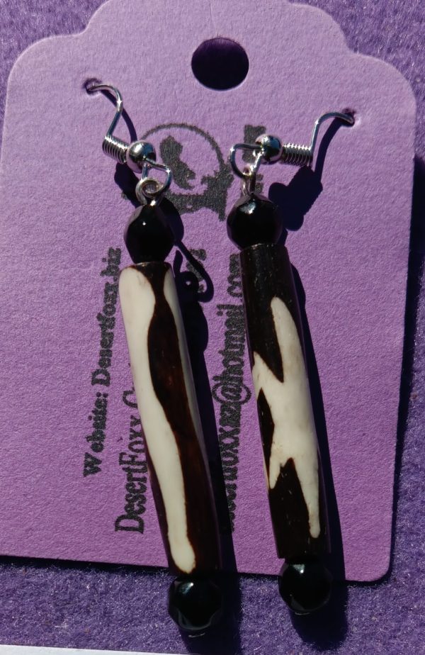 Approx. 2 1/4 inches, Long bead with cream and brown stripes and black beads with silver ear wires. 22.00
